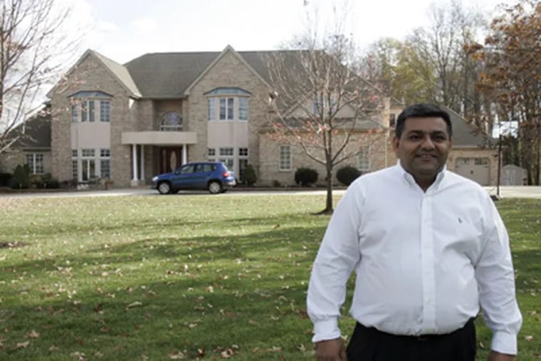 Paul Patel stands in front of his Pennsville, N.J. home. Patel has benefited from a New Jersey pilot program that gives utility incentives to help customers conserve energy. (Bonnie Weller / Staff Photographer)