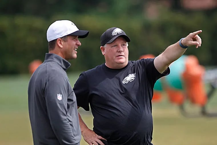 Baltimore ravens head coach John Harbaugh, left, and Philadelphia Eagles head coach ,Chip Kelly, right, share a moment together before their combined practice at the Eagles NovaCare Center on Wednesday, August 19, 2015.