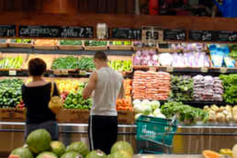 Shoppers check the produce at the Glen Mills Fresh Market. Eggs, cereals, and fresh vegetables led the decline in food prices.