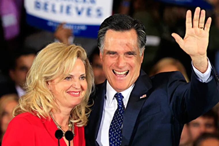 Mitt Romney and his wife, Ann, wave at his election night party in Novi, Mich., on Tuesday.