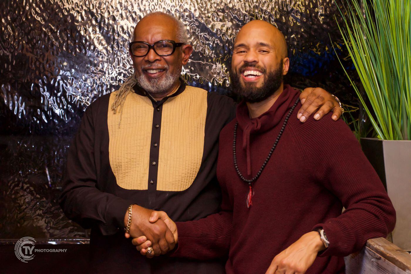 George Timbers, a mental health care provider for Black Men Heal, and organization supporter Greg Corbin at the group's December 2018 provider appreciation event at Manayunk Brewing Company.
