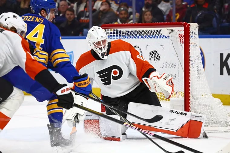 Flyers goaltender Ivan Fedotov (right), making his first NHL start, stops a shot by Buffalo's Dylan Cozens in the first period.