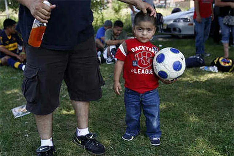 Come Sunday, soccer leagues are a hands-down winner in many area neighborhoods. In Camden, 2-year-old Robert Gonzalez and his father, Victor, are ready for action to begin. (Michael S. Wirtz / Staff Photographer)