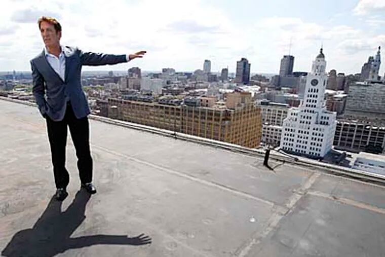 Developer Bart Blatstein, atop the Tower Place at Broad and Spring Garden Streets, gestures toward the former Inquirer building, which he proposes to turn into a casino-hotel complex. DAVID MAIALETTI / Staff Photographer