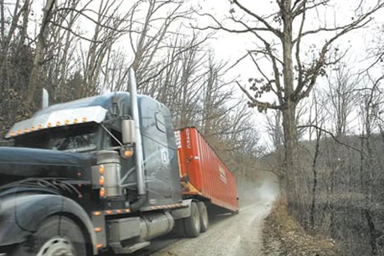 A truck hauls away a container which held water at the drilling site. Forest roads will see increased usage as drilling continues. (Michael S. Wirtz / Staff Photographer )
