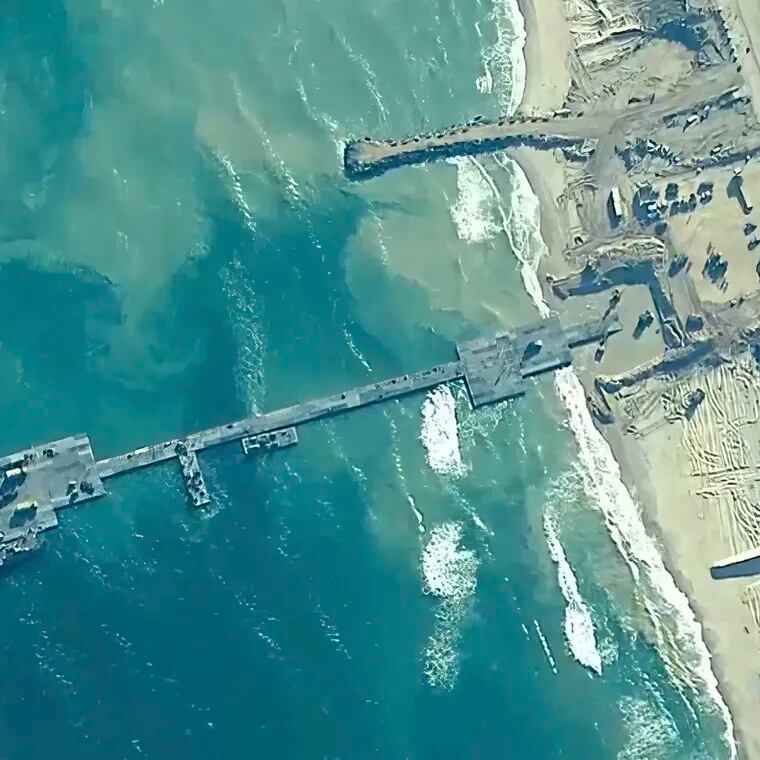 The image provided by U.S, Central Command, shows U.S. Army soldiers assigned to the 7th Transportation Brigade (Expeditionary), U.S. Navy sailors assigned to Amphibious Construction Battalion 1, and Israel Defense Forces placing the Trident Pier on the coast of Gaza Strip on Thursday, May 16, 2024. The temporary pier is part of the Joint Logistics Over-the-Shore capability. The U.S. military finished installing the floating pier on Thursday, with officials poised to begin ferrying badly needed humanitarian aid into the enclave besieged over seven months of intense fighting in the Israel-Hamas war.