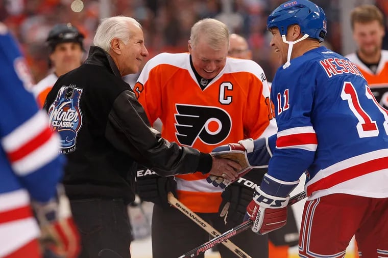 Ed Snider greets ex-Ranger Mark Messier as ex-Flyer Bob Clarke watches before the drop of the puck at an alumni game on Dec. 31, 2011 at Citizens Bank Park. The alumni game was part of the NHL's Winter Classic. Snider died Monday at the age of 83.