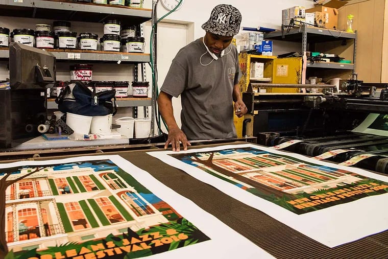 Joe Edwards checks the ink at DMR Graphics in West Conshohocken. DMR's posters for the New Orleans Jazz & Heritage Festival have become collector's items..