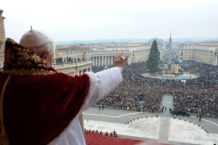 Pope Benedict XVI waves to the faithful during the &quot;Urbi et Orbi&quot; message in St. Peter&#0039;s Square. He urged people to work together in tough times. &quot;If people look only to their own interests,&quot; the pontiff warned, &quot;our world will certainly fall apart.&quot;