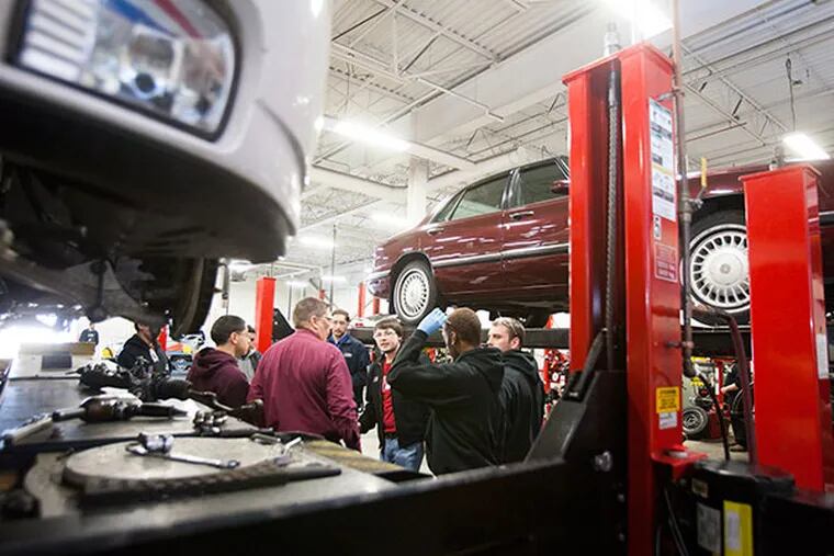 Students diagnose problems on training cars and simulators at the Universal Technical Institute in Exton Thursday, February 6, 2014 . ( Ed Hille / Staff Photographer)