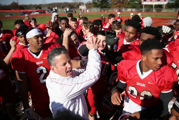 Lenape head coach Tim McAneney celebrates with his team after their annual Thanksgiving day game against Shawnee.