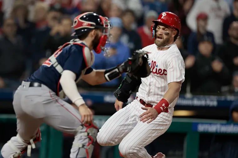 Bryce Harper slides home to score in the fourth inning Friday. Harper went 1-for-4 with a run scored in his first game at Citizens Bank Park this season.