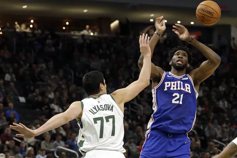 Bucks forward Ersan Ilyasova, a former Sixer, knocks the ball out of Joel Embiid's hands during the Sixers' loss to the Bucks on Thursday.