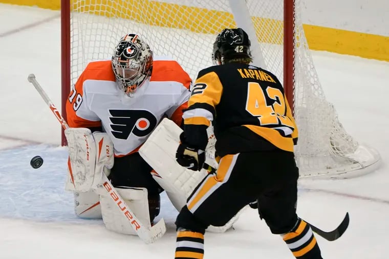 Flyers goaltender Carter Hart stopping a shot by Pittsburgh's Kasperi Kapanen during the third period of the Penguins' 5-2 win Tuesday. Kapanen scored a pair of goals in the game.