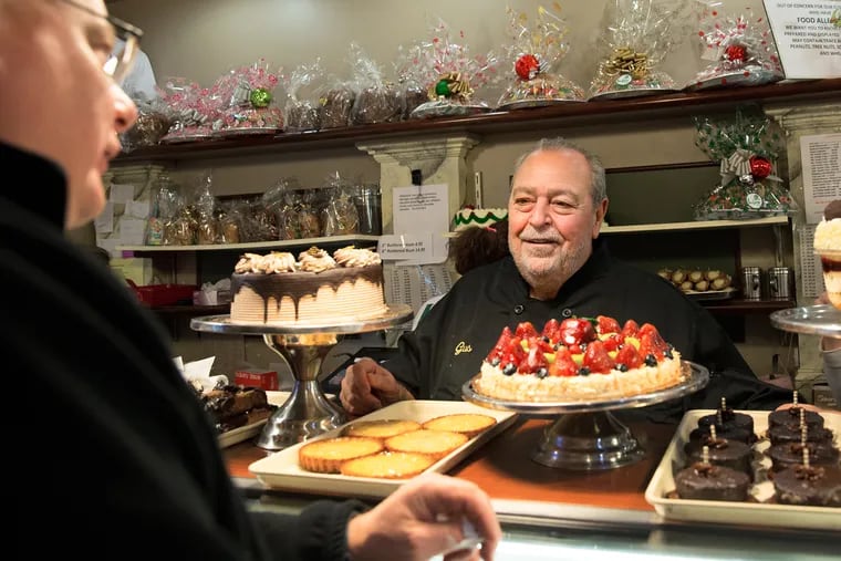 Gus Isgro, center, shown at Isgro's bakery at 1009 Christian St., in Philadelphia, has been In the business all his life.