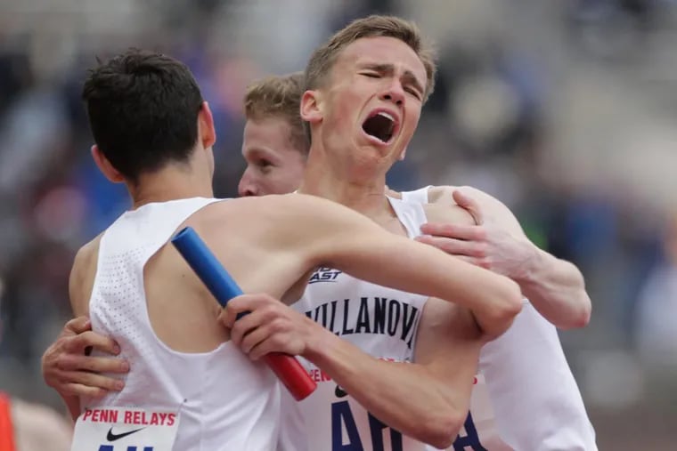 Villanova’s Casey Comber, facing camera is mobbed by teammates after crossing the finish line in the men’s distance medley relay championship of america on April 27.