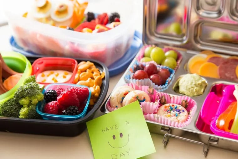A note of encouragement with a colorful Bento box lunch packed with healthy fruits, veggies and snacks.