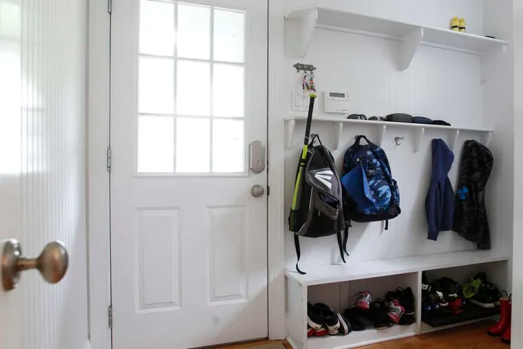 This mudroom has storage space for sneakers and rain boots and kid-height hooks.