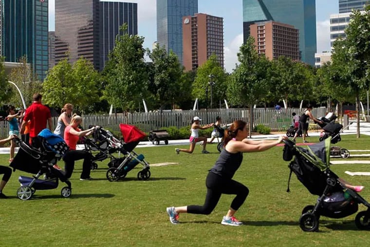 Moms with strollers exercise with their babies in tow during Stroller Boot Camp at Klyde Warren Park in Dallas, on Tuesday, June 3, 2014. (Lara Solt/Dallas Morning News/MCT)