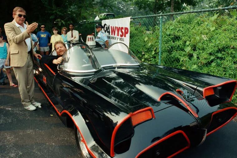 Adam West (left), Batman in the 1960s TV show, stands beside an original Batmobile from the series, in Philadelphia in 1989.