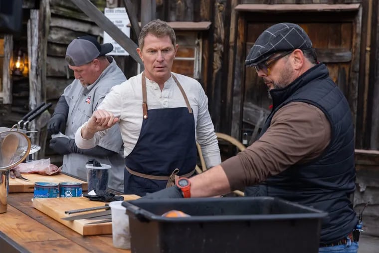 Chef Brian Duffy (right) gets feedback from Bobby Flay on Season 4 of "BBQ Brawl" on Food Network.