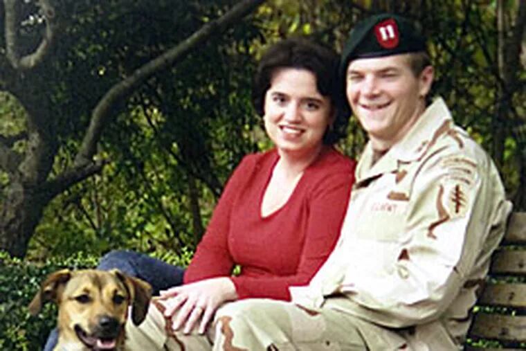 Army Capt. Charles Robinson, his wife, Laura, and their dog, Buster, in 2004. Charles Robinson, a graduate of Baptist Regional School in Haddonfield, was killed while serving in Afghanistan in June 2005.