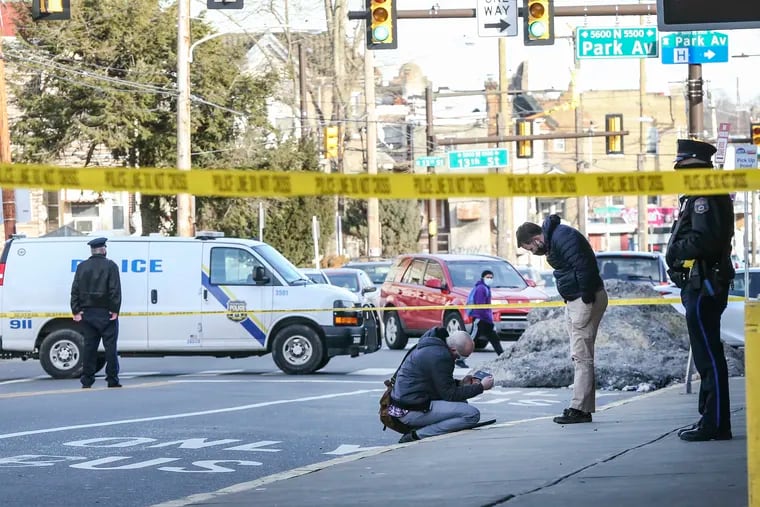 Philadelphia Police investigate the scene at Broad and Olney where eight people were shot at about 3 p.m. Wednesday,  Feb. 17, 2021.