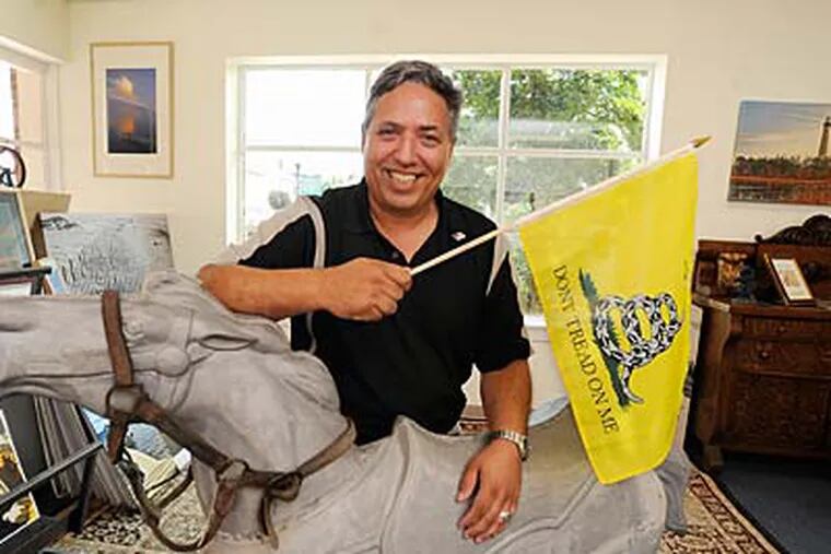 Peter DeStefano holds a “Don’t Tread on Me” flag in his Mount Holly frame shop. He is running against Rep. John Adler, a Democrat, and Republican Jon Runyan in New Jersey’s Third District. (CLEM MURRAY / Staff Photographer)