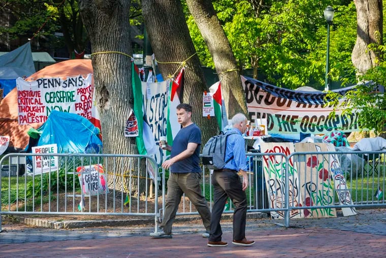 Pedestrians making way past a Pro-Palestine encampment on the campus of the University of Pennsylvania in April.