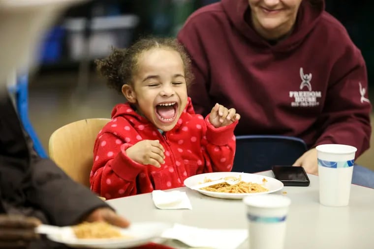 Laurianna Toth, 4, laughs with her mom, Laura Toth, while eating spaghetti during the final cooking class and celebration at Robert B. Pollock Elementary School in Philadelphia, Pennsylvania on Tuesday, November 26, 2019. Throughout the semester the students learned different cooking techniques and recipes.