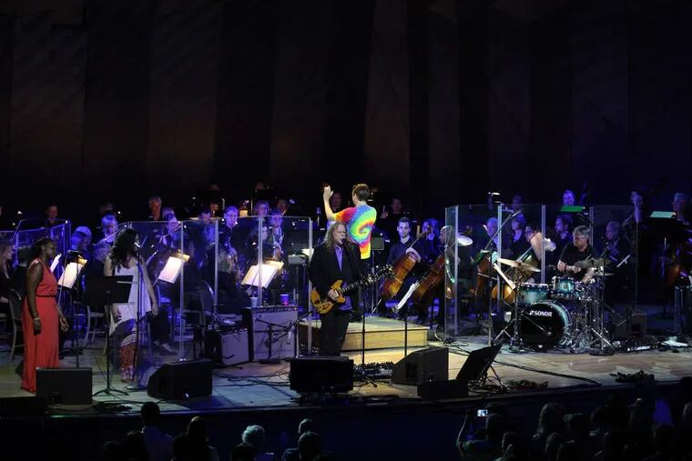 Guitarist Warren Haynes performing at the Jerry Garcia Symphonic Celebration with the Boston Pops at Tanglewood on Saturday. That's conductor Keith Lockhart in the groovy T.