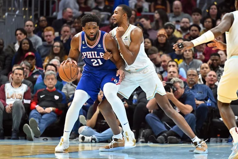 Joel Embiid (21) posts up against the Cavaliers' Evan Mobley during the second half Wednesday night.