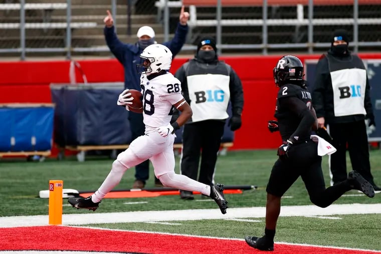 Penn State running back Devyn Ford scores a touchdown past Rutgers defensive back Avery Young on Saturday.
