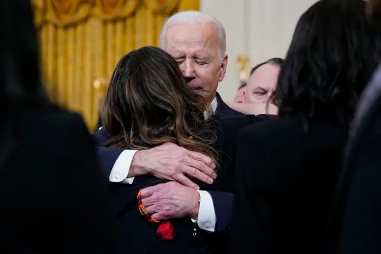 President Joe Biden hugs Kathryn Sherlock, mother of Kayden Mancuso, a 7-year-old who was killed, at an event to celebrate the reauthorization of the Violence Against Women Act in the East Room of the White House, Wednesday, March 16, 2022, in Washington. Kayden's biological father, Jeffrey Mancuso, killed the young girl inside his Philadelphia home before taking his own life.