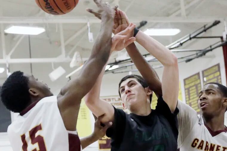 West Deptford’s MJ Iraldi (center) battles Haddon Heights # 15 Isaha Waters and # 5 Isaiah Turner for a 2nd half rebound during the West Deptford at Haddon Heights H.S. boys' basketball game on February 27, 2019.