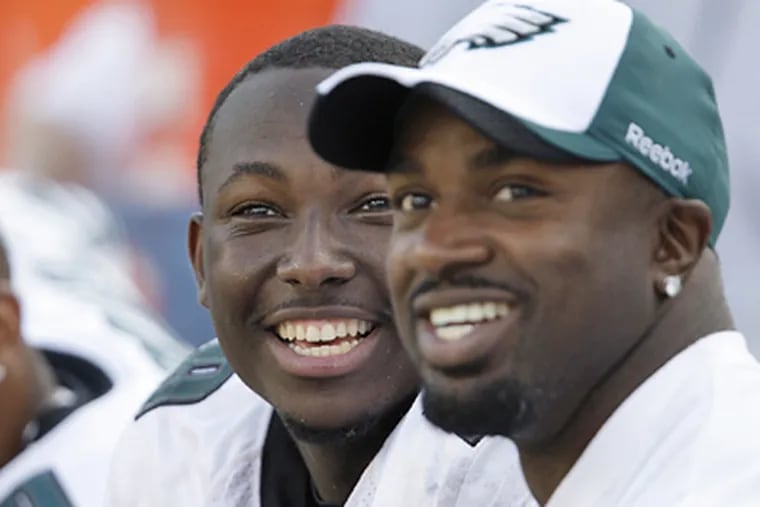 LeSean McCoy, center, smiles as he sits on the bench with Brian Westbrook during the Eagles' win over the Kansas City Chiefs. (David Maialetti / Staff Photographer)