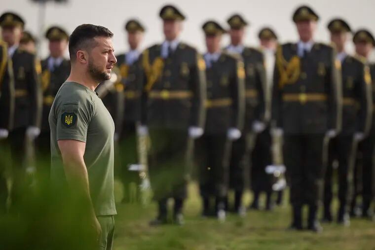 In this photo provided by the Ukrainian Presidential Press Office, Ukrainian President Volodymyr Zelenskyy stands in front of lined up soldiers as he arrives for State Flag Day celebrations in Kyiv, Ukraine, Tuesday, Aug. 23, 2022.