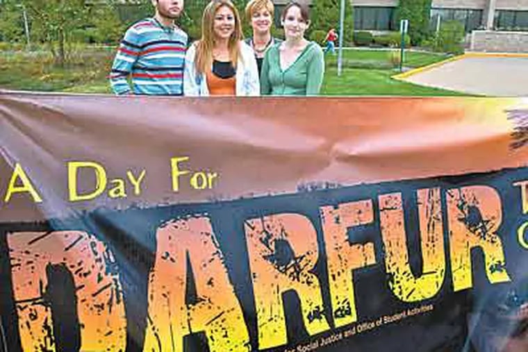 Burlington County College students Sean Parsons, Laura Dyer and Liz Lofton with associate dean Cathy Biggs (rear) prepare for Darfur-awareness events on campus.