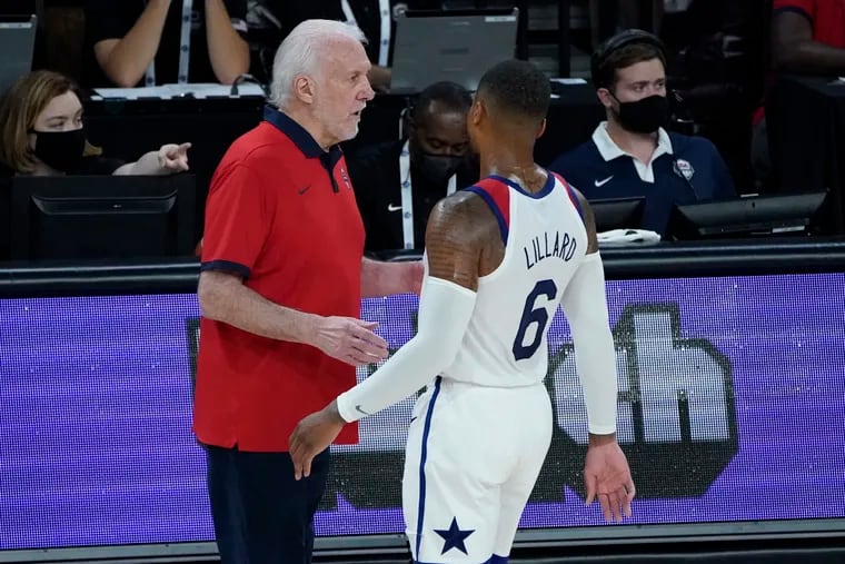 Damian Lillard, right, talks with U.S. head coach Gregg Popovich during an Olympic warmup exhibition game on Sunday.