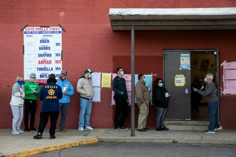 People line up to vote at the Stephen Decatur Elementary School polling place on Election Day in Philadelphia on Nov. 3, 2020.