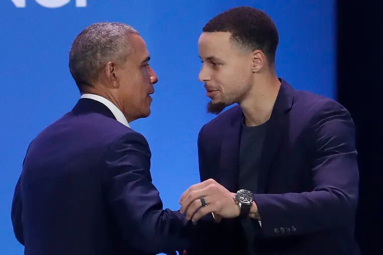 Former President Barack Obama, left, hugs Golden State Warriors basketball player Stephen Curry after speaking at the My Brother's Keeper Alliance Summit in Oakland, Calif., Tuesday, Feb. 19, 2019.