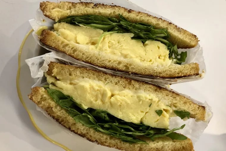 Classic breakfast sandwich from Middle Child includes fluffy eggs, Cooper Sharp American, and arugula.