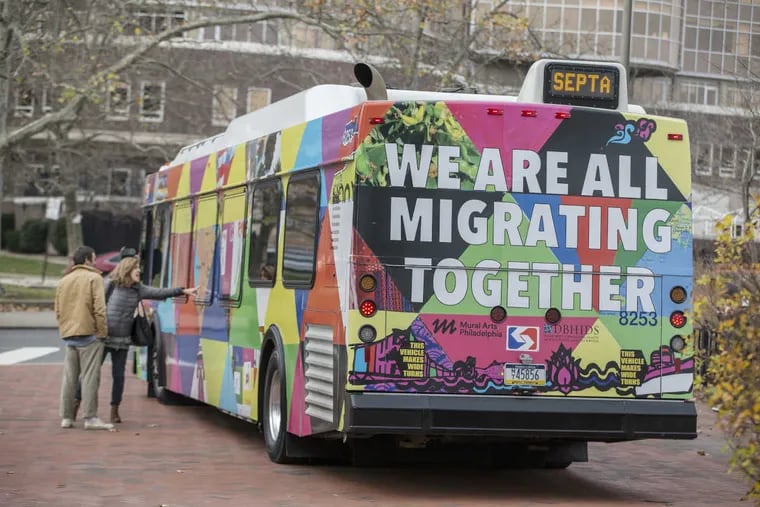 The back of the Route 47 bus states &#039;We Are All Migrating Together&#039; as it sits on display at Franklin Square.