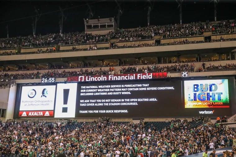 The Jumbotron in the southern part of the stadium flashes a sign for spectators to leave their seats and shelter in the concourse of Lincoln Financial Field until the storm passes.