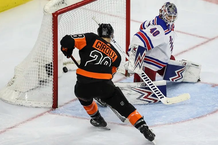 Claude Giroux putting a power-play goal past Rangers goalie Alexandar Georgiev at the Wells Fargo Center on Feb. 28. The Flyers won, 5-2.