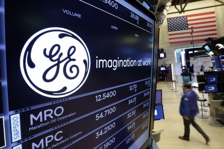 The GE logo appears above a trading post on the floor of the New York Stock Exchange. Can John Flannery, the new CEO turn around this behemoth.