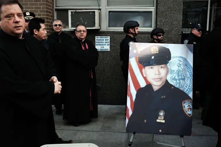 A picture of Wenjian Liu outside the 84th Precinct. The grief displayed by his father, Wei Tang Liu, and widow, Sandy, brought many to tears.
