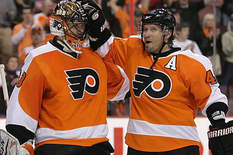 Brian Boucher and Kimmo Timonen celebrate after the Flyers' Game 4 win over the Devils. (Yong Kim/Staff Photographer)