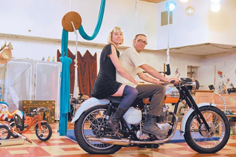 Lhianna and Clarence Bodiford pose on their Triumph motorcycle in the  downstairs "ballroom" of their home. (Tom Gralish / Staff Photographer)