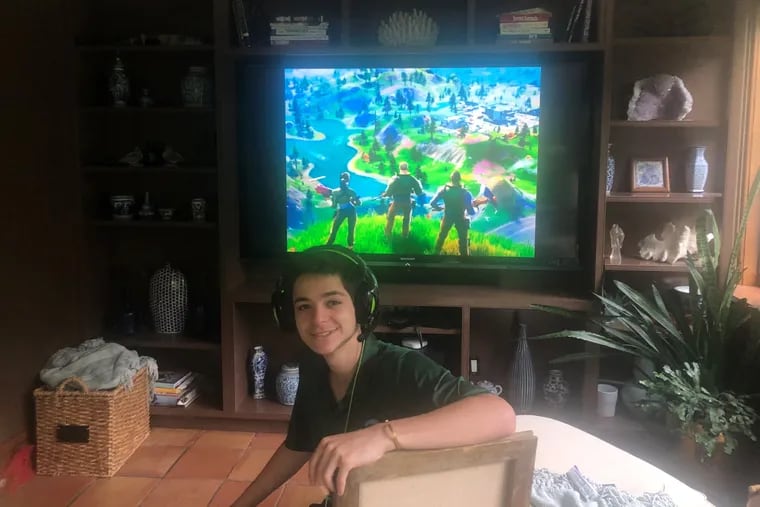 Jack Robinson, 18, a Shipley School graduating senior from Penn Valley, will join with two classmates to play the video game Fortnite (seen on the screen) for 24 hours this week to raise money for nurses battling coronavirus.